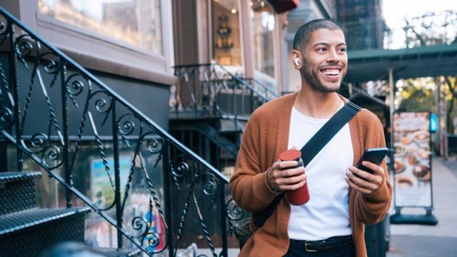 Man with a phone walking in Brooklyn in NYC